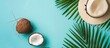 © Lasvu - Summer vibes: Tropical palm leaves, hat, and coconut on a soft blue backdrop. Embracing the essence of summer with a flat lay arrangement, offering a top view and ample room for creativity.
