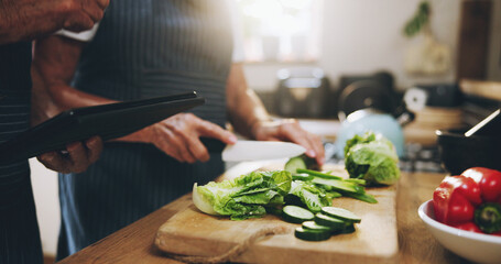 Hands, tablet and salad recipe in kitchen with help, support and teaching at home for healthy food. People cooking lunch on digital tech for nutrition tips with lettuce, cucumber and green vegetables