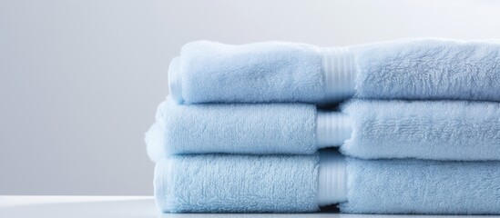 Wall Mural - A copy space image of white isolated towels made of blue cotton