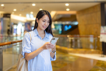 Wall Mural - Asian pregnant woman use of mobile phone in shopping mall