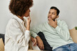 © Bliss - An African American couple uses sign language to communicate while relaxing at home.