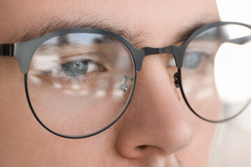 Sticker - Man wearing glasses on blurred background, closeup