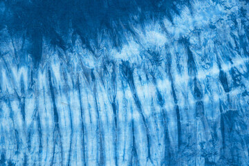 pattern of blue tie batik dye on cotton cloth, dyed indigo fabric background and textured