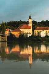 Wall Mural - An image of a lake and a bridge with some buildings