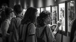 © HNXS Digital Art - Group of multi-ethnic visitors scanning QR codes to get more information about black and white photos on display at a museum exhibition