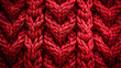 © Maxime - a close up of a red knitted fabric