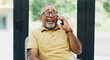 © peopleimages.com - Home, phone call and funny with senior man, communication and network with joke, digital app and smile in living room. Pensioner, apartment and happy mature guy with smartphone, humor and laughing