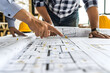 © Zuhaili - Architect discuss about construction refer to blueprints.