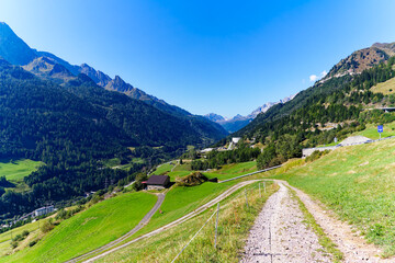 Wall Mural - Scenic landscape at hiking trail above mountain village of Airolo in the alps on a sunny late summer day. Photo taken September 10th, 2023, Gotthard, Switzerland.