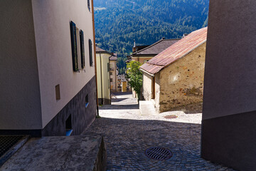 Wall Mural - Scenic view of alley at Swiss mountain village Airolo on a sunny late summer noon. Photo taken September 10th, 2023, Airolo, Canton Ticino, Switzerland.