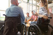 © Robert Kneschke - People interacting in a cafe setting including a person using a wheelchair