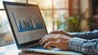 © Plaifah - A businessman analyzing stock market trends on a laptop, with charts and graphs displayed on the screen.