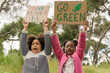 © ADDICTIVE STOCK - Young activists holding environmental signs in a park