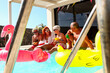 © ADDICTIVE STOCK - Seniors Enjoying a Sunny Pool Party with Floats