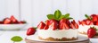 © vxnaghiyev - Summer dessert of no-bake cheesecake topped with fresh strawberries on a white wooden backdrop, featuring selective focus and ample copy space image.