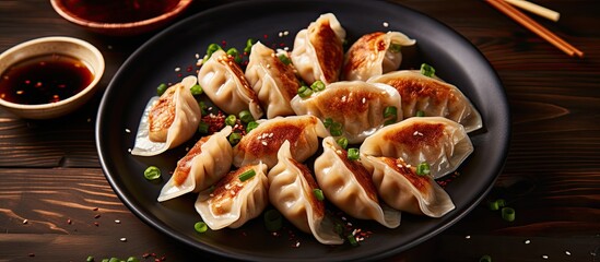 Poster - Top view of Japanese and Korean gyoza dumplings on a gray plate on a table with copy space image.