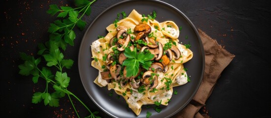 Poster - Overhead shot of mushroom pappardelle with creamy sauce and parsley on a stone background with copy space image.