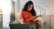 © CoetzeeRising/peopleimages.com - Home office, business woman and tablet for freelance, reading information and planning as creative agency. House, female graphic designer and laptop for design inspiration, feedback and remote work