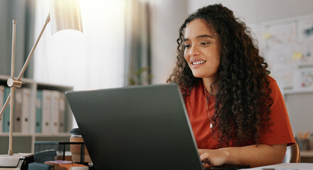 Wall Mural - Research, woman and smile at desk with laptop, communication and update in office. Female journalist, typing and happy at computer for article, social media and contact in modern workplace in city