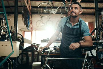 Wall Mural - Man, bicycle shop and thinking for maintenance work, startup with transport service. Bike, mechanic and Male entrepreneur in workshop with idea, thoughtful for sustainable business with apron