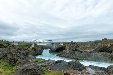 Icelandic landscape of the body of water, lakes and waterfall on a cloudy day from Akureyri