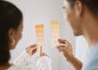 © peopleimages.com - Couple, home and color palette for planning for interior design, woman and pointing for improvement idea. Renovation, inspiration and wall decor with man, relationship bonding and house project