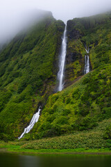 Cascata da Ribeira do Ferreiro, Flores Island, Azores, Portugal. Long exposure waterfalls. Waterfall with tropical green vegetation and forests. Travel destination. Hiking on Azores Islands.