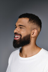 Wall Mural - A close-up of a handsome young man with a beard, focused on his skin care routine.