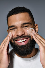 Wall Mural - A bearded man happily applying cream on his face.