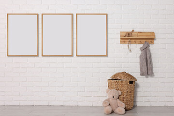 Wall Mural - Room for child with blank pictures on white brick wall. Interior design