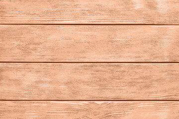Wall Mural - Wooden surface of peach fuzz color, top view. Trendy shade of 2024 year