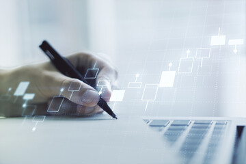 Double exposure of abstract creative financial chart with hand writing in notebook on background, research and strategy concept