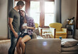 © Reese Coop/peopleimages.com - Couple, coffee and home with love, living room and smile in marriage, relax and peace in break and morning. House, man and woman on sofa, together and rest in lounge bonding or happy for relationship