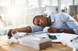 © peopleimages.com - Sleep, sick and black man on desk with flu, allergy and sinusitis or fatigue by laptop with tissues. Overworked, tired and person with illness for rest, burnout and recovery in office with symptoms