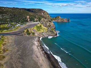 Wall Mural - 'lion rock' covered in green bush sticks out into the tasman sea on the coast of auckland new zealan
