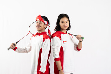 Young Asian Indonesian men and women wearing Indonesian clothes are holding rackets and playing badminton. isolated white background