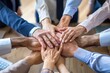 © ArtmediaworX - Group of co-workers with hands stacked one on top of another. Friendship, support, togetherness. Businesspeople with hands touching on top of each other. Ai generative