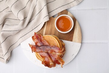 Sticker - Delicious pancakes with bacon and honey on white tiled table, top view