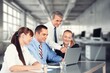 © BillionPhotos.com - Happy business people discussing project in office