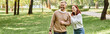 © LIGHTFIELD STUDIOS - A man and a woman enjoying a leisurely walk through a peaceful park on a sunny day.