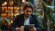 © Anderson Piza - Engrossed Entrepreneur with Tablet in Modern Office Lounge Area