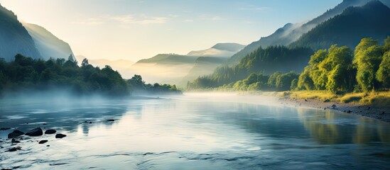 Poster - Scenic river scene with misty morning atmosphere and mountains in the background. with copy space image. Place for adding text or design
