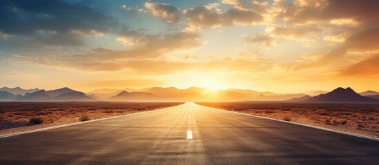 Wall Mural - the long desert road seems to vanish as the blazing sun sets in the distance. with copy space image.