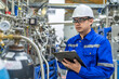 © reewungjunerr - Asian engineer working at Operating hall,Thailand people wear helmet  work,He worked with diligence and patience,she checked the valve regulator at the hydrogen tank.