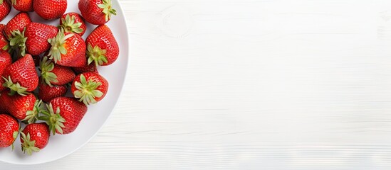 Poster - Fresh, sweet strawberries arranged on a white plate, with a top view of the red fruits in a white bowl. with copy space image. Place for adding text or design