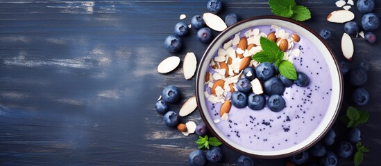 Aufkleber - A vibrant blueberry smoothie bowl topped with crunchy almonds and fresh mint leaves. with copy space image. Place for adding text or design