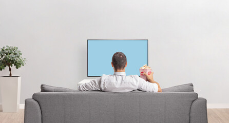 Canvas Print - Rear view shot of a man in front of a tv screen