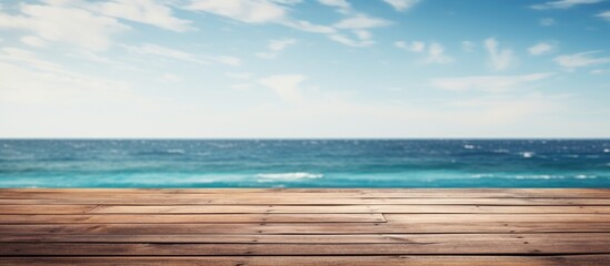 Fototapete - Wooden deck provides a peaceful vista of the ocean under a clear blue sky with fluffy clouds. with copy space image. Place for adding text or design