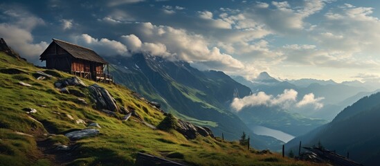 Poster - Old wooden house perched atop a mountain surrounded by green meadows. with copy space image. Place for adding text or design