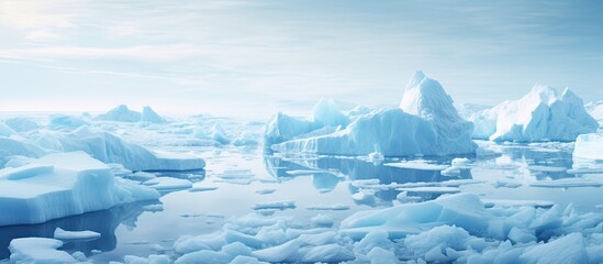 Fototapete - Icebergs peacefully float in the ocean while the sky looms above, showcasing a serene and chilly scene. with copy space image. Place for adding text or design
